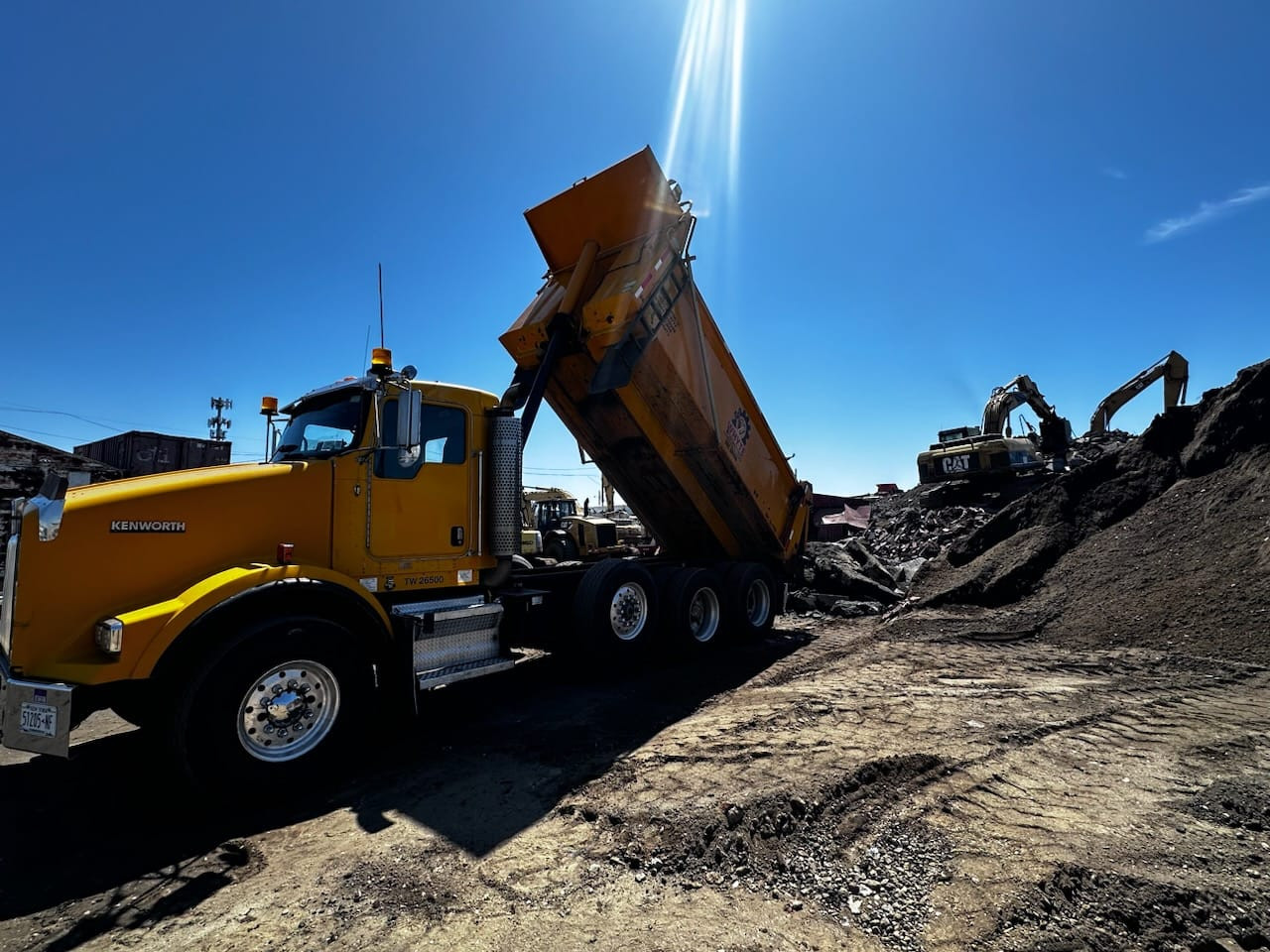 Whyte Contracting dump truck dumping material on job site